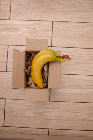 Banana fruit in a brown paper recycled boxの写真素材