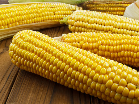 ripe corn on wooden table