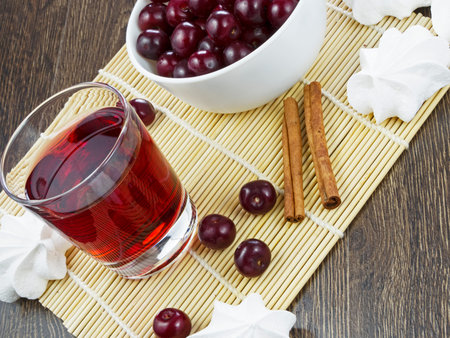 cherry juice in a glass on wooden table