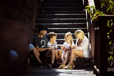 Family happiness generation home and people concept happy family standing in front of houseの写真素材