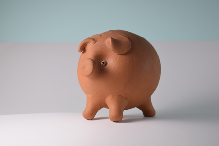 Piggy bank of white and blue backgroundの写真素材
