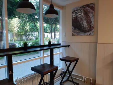 A cozy place for coffee and delicious food is the table and chairs in the Bulko cafe. Yoshkar-Ola city, Republic of Mari El, Russia. Jule 18, 2021のeditorial素材