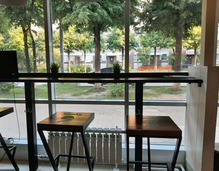 A cozy place for coffee and delicious food is the table and chairs in the Bulko cafe. Yoshkar-Ola city, Republic of Mari El, Russia. Jule 18, 2021のeditorial素材
