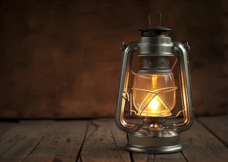 Oil Lamp at Night on a Wooden Surfaceの写真素材
