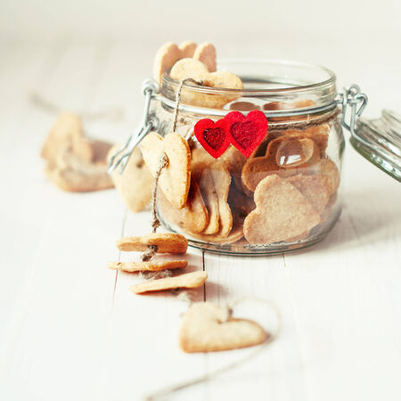Festive Cookies on cord in the Jar Decorated with Two Red Heartsの写真素材