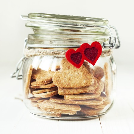 Light Cookies in the Jar Decorated with Two Red Hearts and cordの写真素材