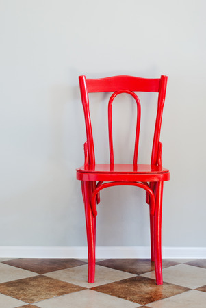 Red Chair on Tiled Floor and Near Grey Wall, indoorの写真素材