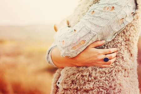 The Woman Embraces Herself Hands, Ring in the finger, outdoorの写真素材