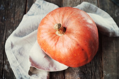Pumpkin with a Napkin on Wooden Table. Toned image. Top Viewの写真素材