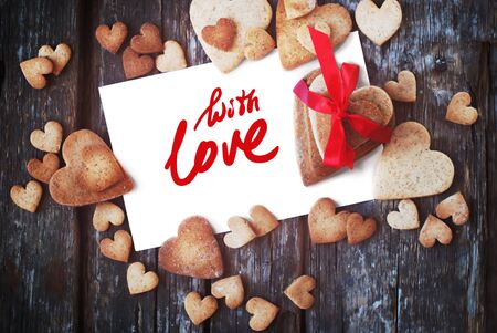 Message With Love on the White Isolated Letter and Gingerbread Cookies in the Shape of Heart at Valentine Day. Selective focusの写真素材
