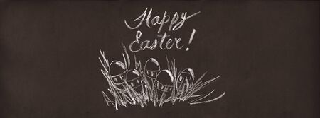 Easter Eggs in Grass Drawing Chalk Illustration Sketch on Brown Chalkboard Backgroundの写真素材