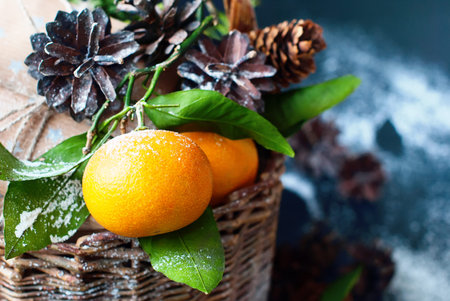 Christmas New Year Composition with Tangerines Boxes Pine cones Greens in Basket Black Background Holiday Decoration to Russian Tradition Drawing Snowfallの写真素材