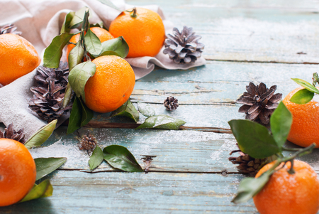 Composition with Tangerines Green Leaves Napkin Pine Cone Wooden Vintage Backgroundの写真素材