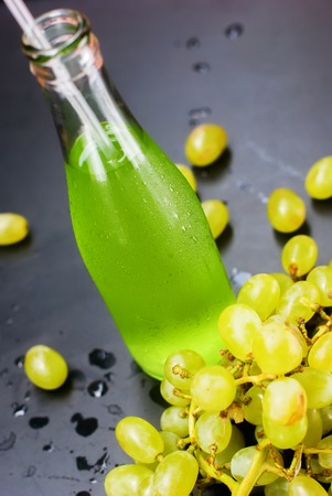 Fresh Green Grapes Juice Smoothie Bottles Tropical Fruits Beverage Black Background Selective focusの写真素材