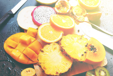 Set Tropical Cut Fruits Water Melon Banana Papaya Pine Apple Agave Mango Passion Fruit Sapodilla Orange Dragon Black Wooden Background Top View Tonedの写真素材