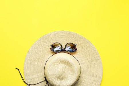 Straw Beach Woman's Hat Sun Glasses Top View Yellow Background Flat Singleの写真素材