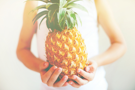 Ripe Juicy Fruit Pineapple in Hands Little Boy Concept of Healthy Food for Children Tonedの写真素材