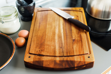 Wooden Chopping Board and Knife on Grey Background Table-top Kitchen Still Life Rustic Dishes Table Wareの写真素材