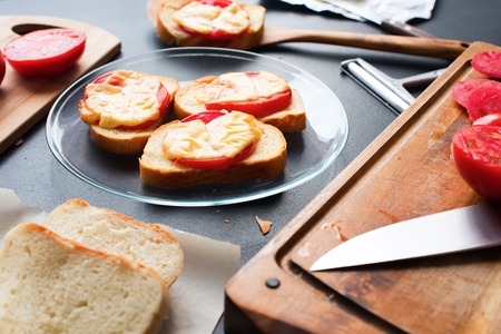 Small Sandwiches with Bread Tomato Cheese Baked Oven Black Table Simple Easy Snackの写真素材