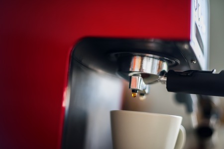 Close-up of Coffee Espresso Pouring from Machine Home Made Cookingの写真素材