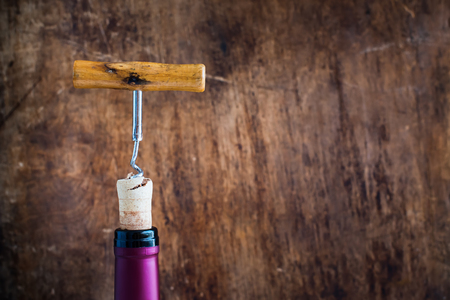 Bottle Wine with Corkscrew on Wooden Background Opening Process Copy Spaceの写真素材