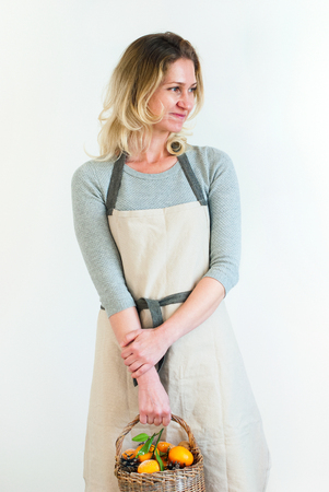 Fair Hair Woman Pastel Vintage Clothes Hands Hold Basket Tangerines Pine Cones Light Wall Holiday Decorationの写真素材