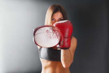 Portrait Power Woman Old Red Boxing Gloves Fighter Kick Punching Fight Sport Gym on Dark Backgroundの写真素材