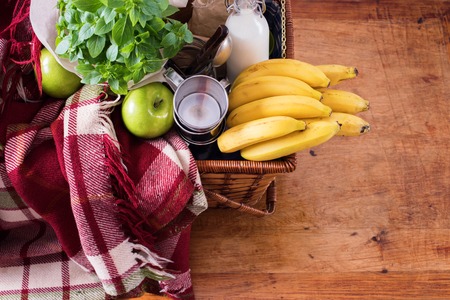 Picnic Wattled Basket Setting Food Bread Baguette Drink Milk Basil Cheese Green Apples Banana Summer Timeの写真素材