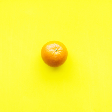 Orange One Whole Tropical Fruit Yellow Background Object Useful Natural Organic Food Style Minimalism Top View Flat Layの写真素材