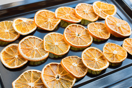Drying segments of oranges in an oven. Row in lineの写真素材