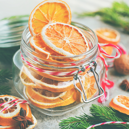 Homemade dried oranges slices in the jar from above.の写真素材