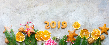2019 year Baked gingerbread cookies star shape and homemade dried oranges slices as decor for fir...