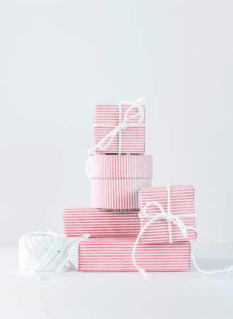 Stack newborn gifts. Festive pink on white