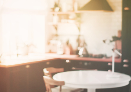 Blurred of home kitchen behind black wooden door with handle. Toned pink faded vintage colorsの写真素材