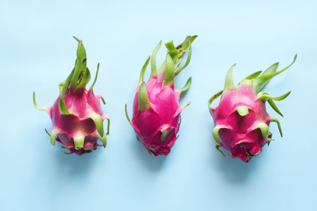 Tree whole pitahaya tropical fruits on blue background. Raw eating concept Summer time. Season local...