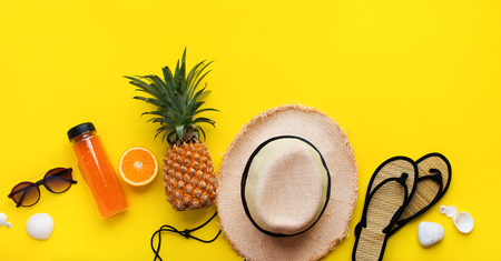 Set of beach things accessories hot season. Straw hat and natural flip flops,shells, glasses, fruits on yellow background. Flat lay. Color concept of travel or vacation holidays. Bannerの写真素材