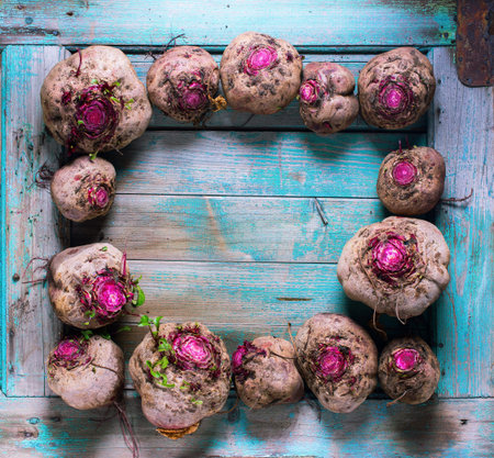 Beetroots in frame on blue wooden background. Rustic style natural organic vegetables food