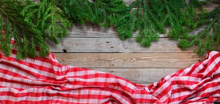 Holiday banner Christmas natural green fir tree spruce and checkered tablecloth on wooden planks vintageの写真素材