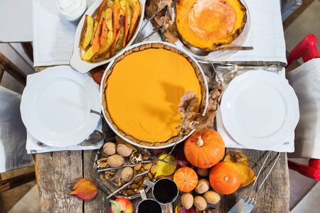 Pumpkin pie. Thanksgiving day celebration traditional dinner setting meal on rustic wooden table.の写真素材