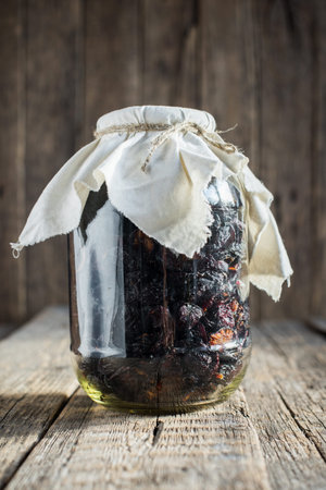 Organic natural healthy dried fruit plum in glass jar on wooden background. Home made rural good foodの写真素材