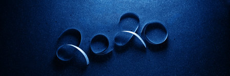 2020 New Year colour banner with numbers from ribbon on blue bright sparkles background. Holiday festive concept. Christmas decoration. Flat layの写真素材