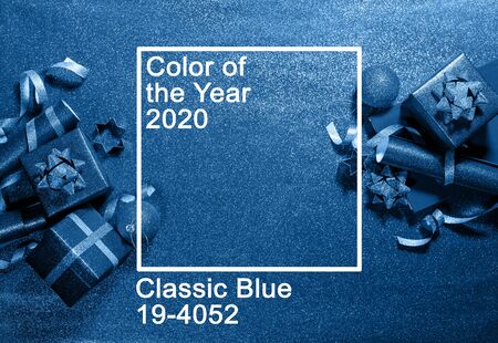 Bright New Year toys balls boxes from blue sparkles on classic brilliant background. Holiday festive concept. Christmas classic decoration. Text Color 2020 above imageの写真素材