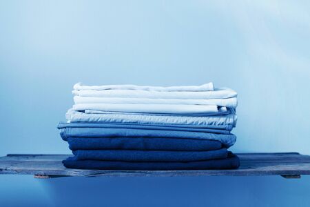 Llinen blue textile stacked pile. sheet and cover. different shades from white to blue color cloth. background. copy spaceの写真素材