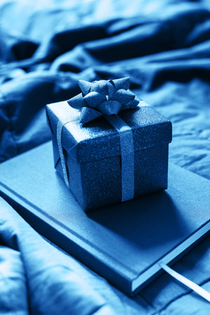 Blue present boxes on pile of daily logs and stack plaid in trend color of the year 2020. Home interior detailの写真素材