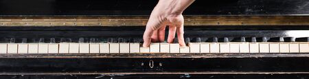Female pianist hands playing on old piano keyboard. Background with selective focus. Vintage retro instrumentの写真素材