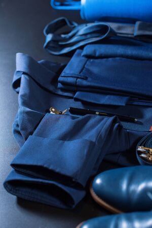 Classic set men clothes blue suit, shoes, belt, watch, notebook, speaker on dark background. Top view. Flat layの写真素材