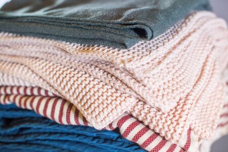 Stack cozy beige blue plaids on grey wall. Home interior detailの写真素材