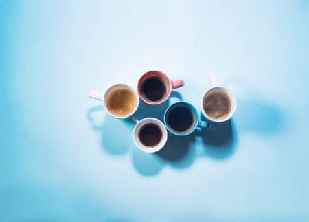 Different fresh group cups of coffee with milk on pastel blue color. Food background. Top view. Flat lay. Minimalismの写真素材