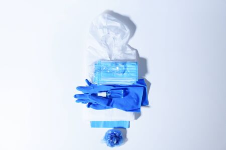 Folding medical protective clothing, masks, glasses and sanitizer are ready to remove to the store room.の写真素材