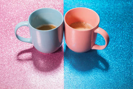 Two cups hot fresh coffee on bright pink blue brilliant paper. Food background. Top view. Flat lay. Minimalismの写真素材